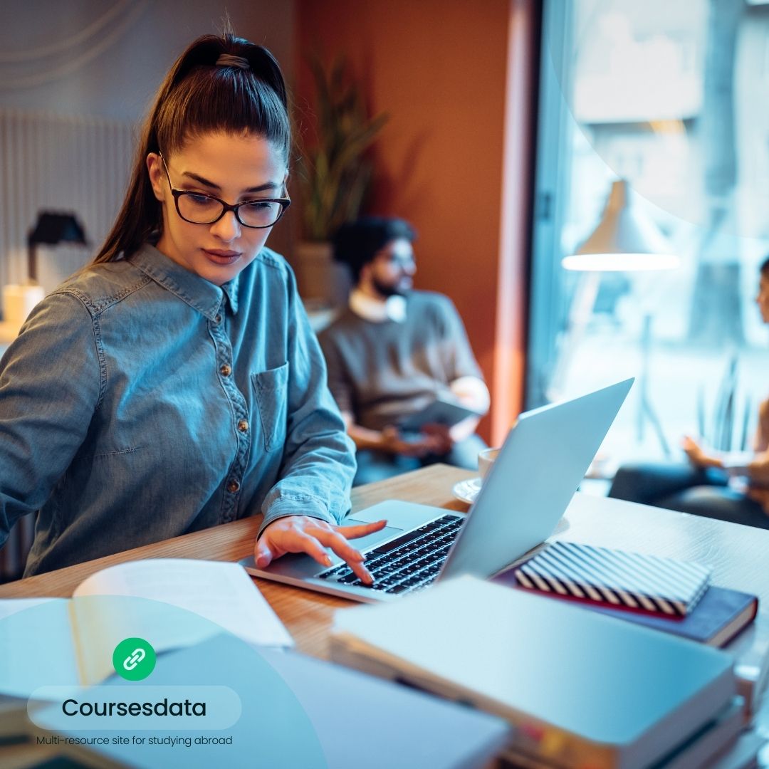 Woman studying with laptop indoors.