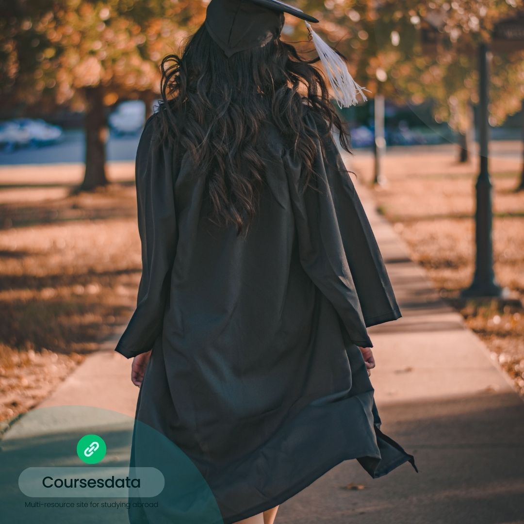 Graduates walking in autumn park.