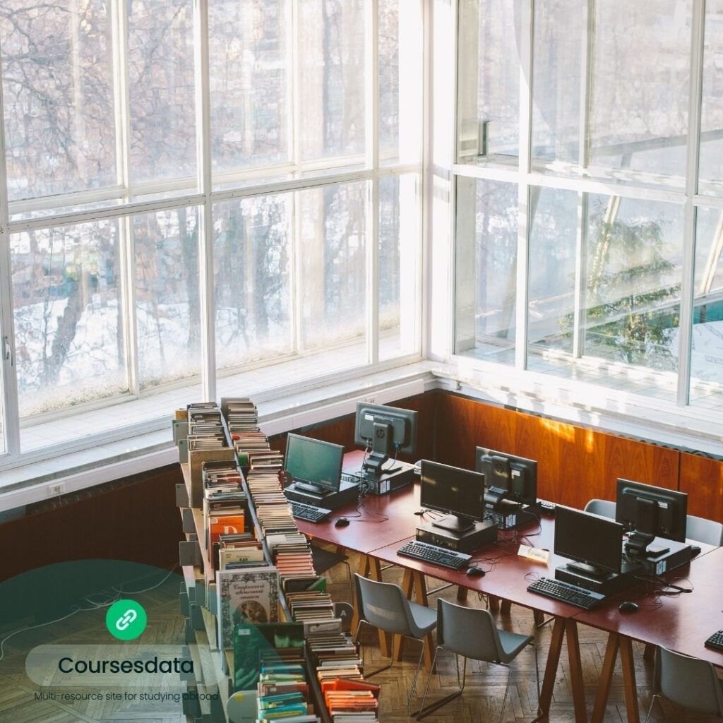 Bright library with computers and books.