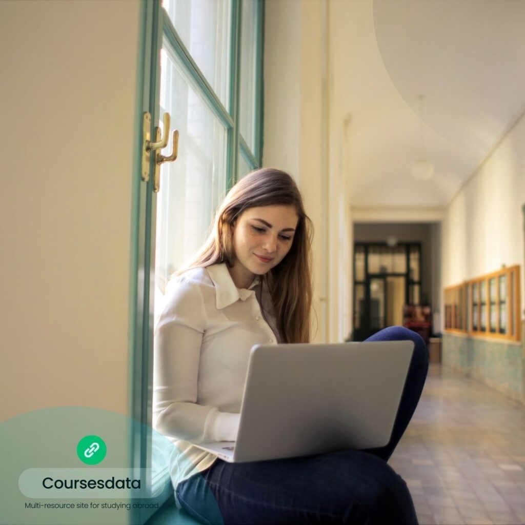 Woman studying on laptop indoors.