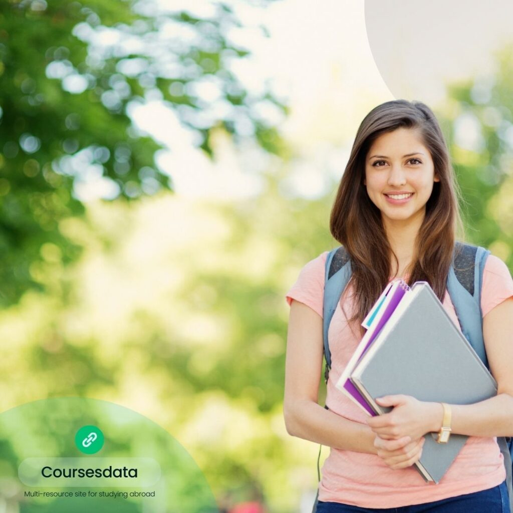 Smiling student holding books.