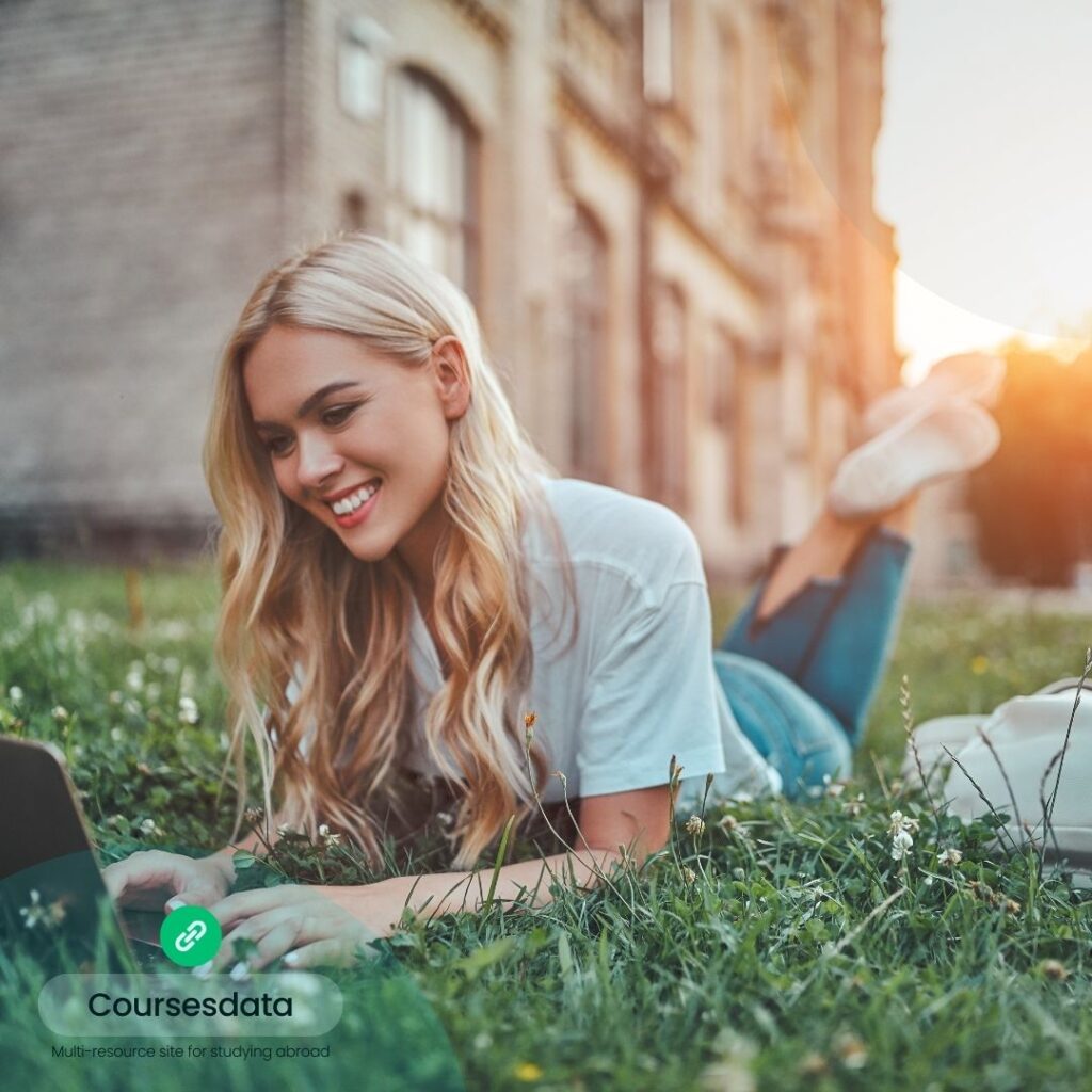 Young woman studying outdoors, smiling.