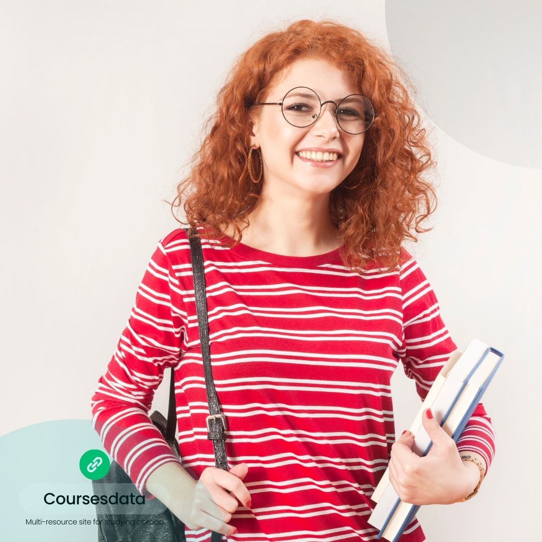Smiling woman with curly red hair.