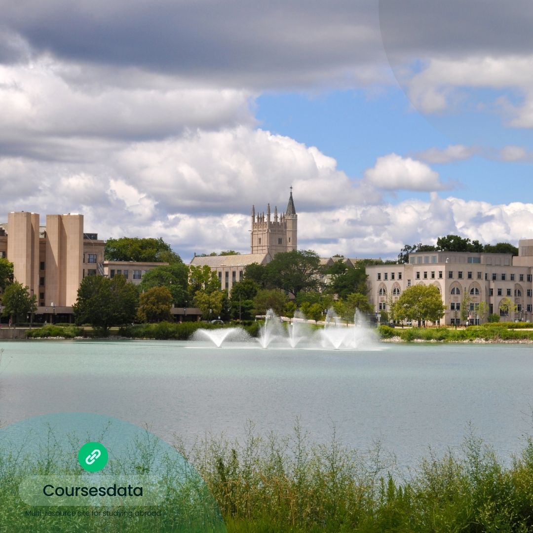 University buildings by serene lake.