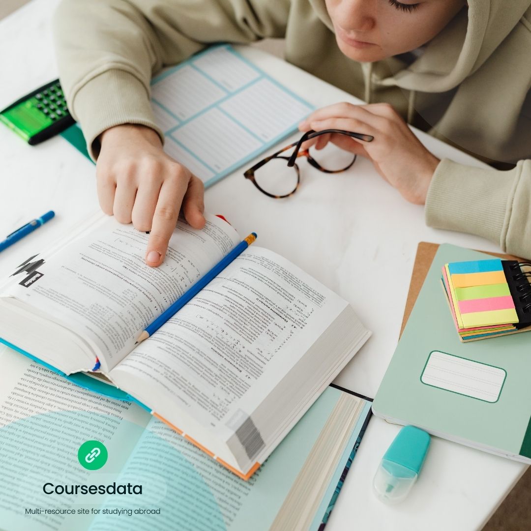 Student studying with open textbook.