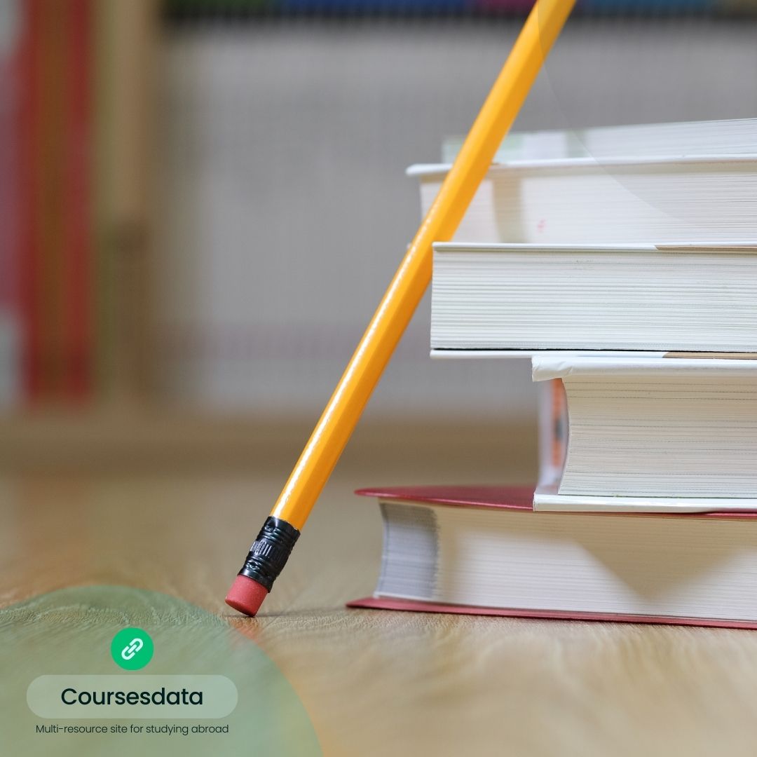 Yellow pencil next to stacked books.