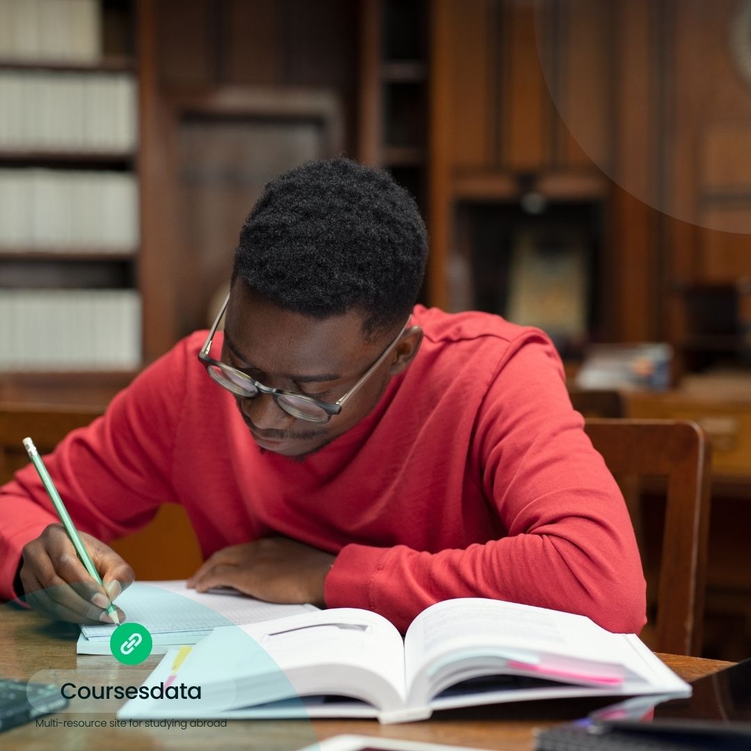 Student studying at library desk.