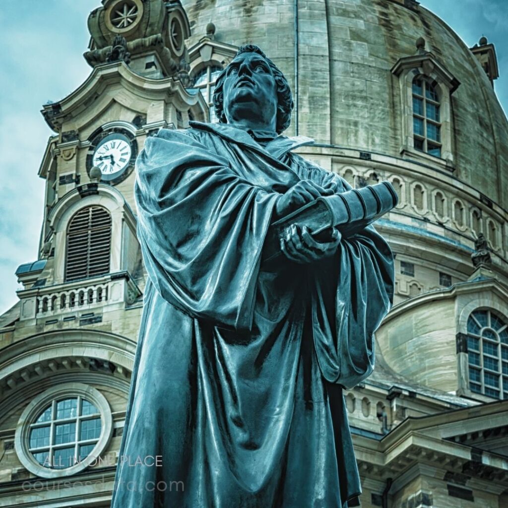 Statue of a scholar, book in hand, historic building backdrop, cloudy sky.