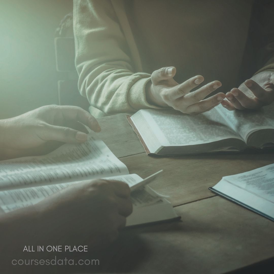 Two hands gesturing over books. Open books on table. Focused discussion or brainstorming. Soft lighting atmosphere.