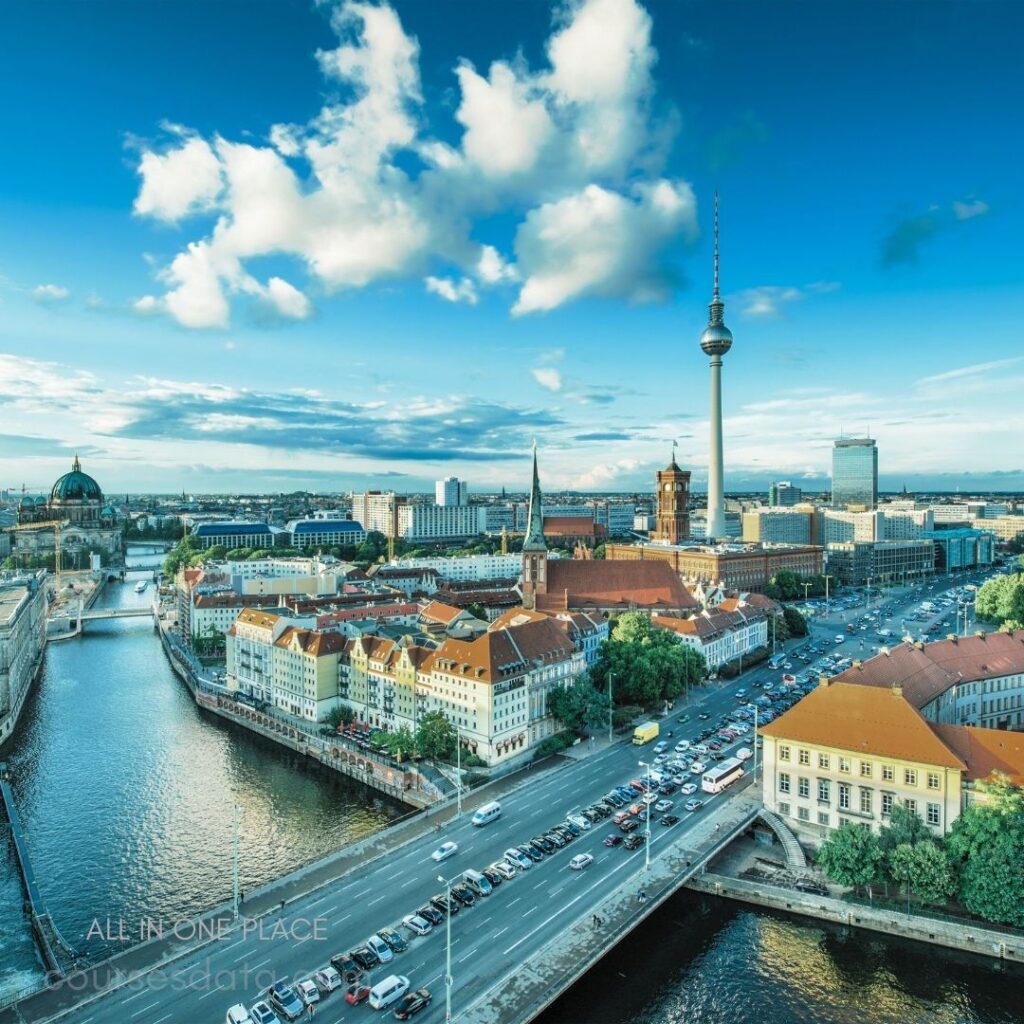 Berlin cityscape with clouds. TV Tower towering over buildings. Historical architecture along the river. Busy road with traffic. Vibrant skyline in daylight.