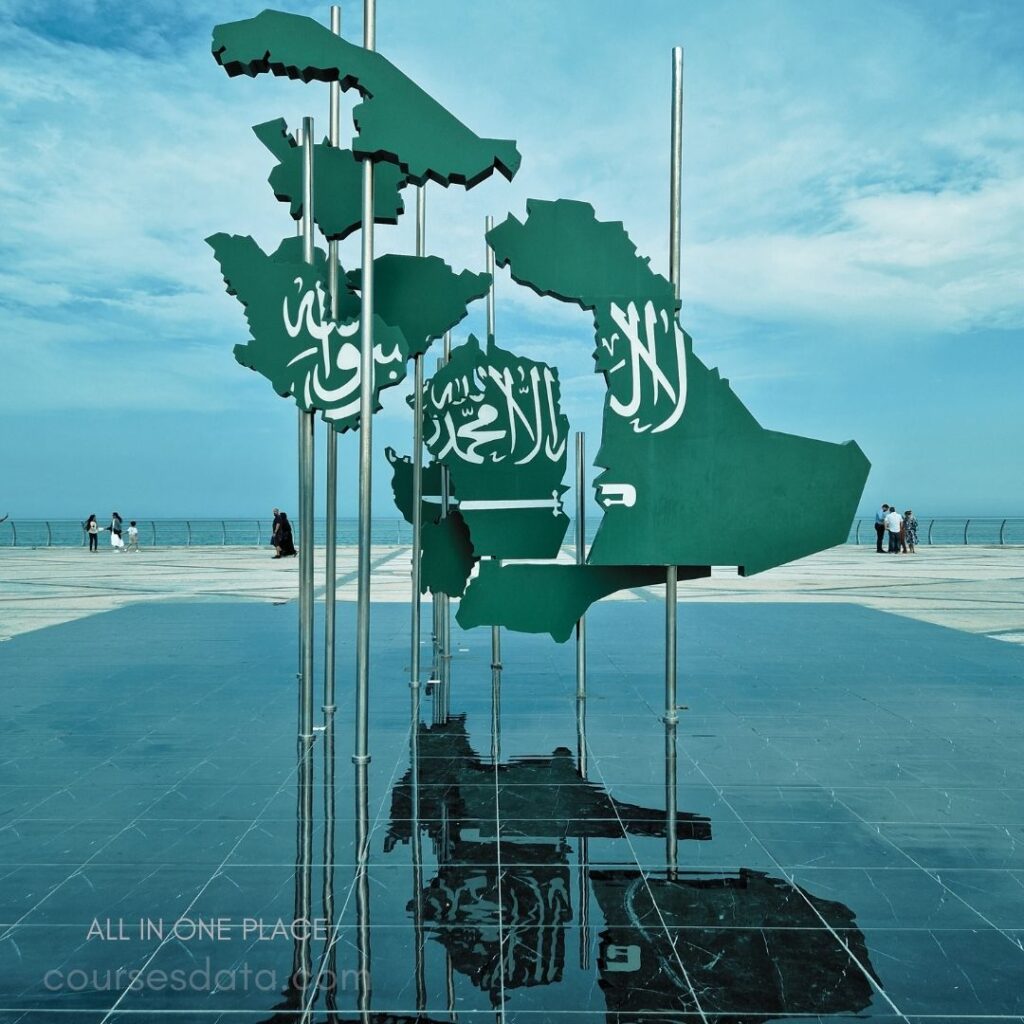 Green sculpture of Middle East. Reflection on polished surface. Seascape and blue sky backdrop. People in the distance walking. Tourist attraction with artistic design.