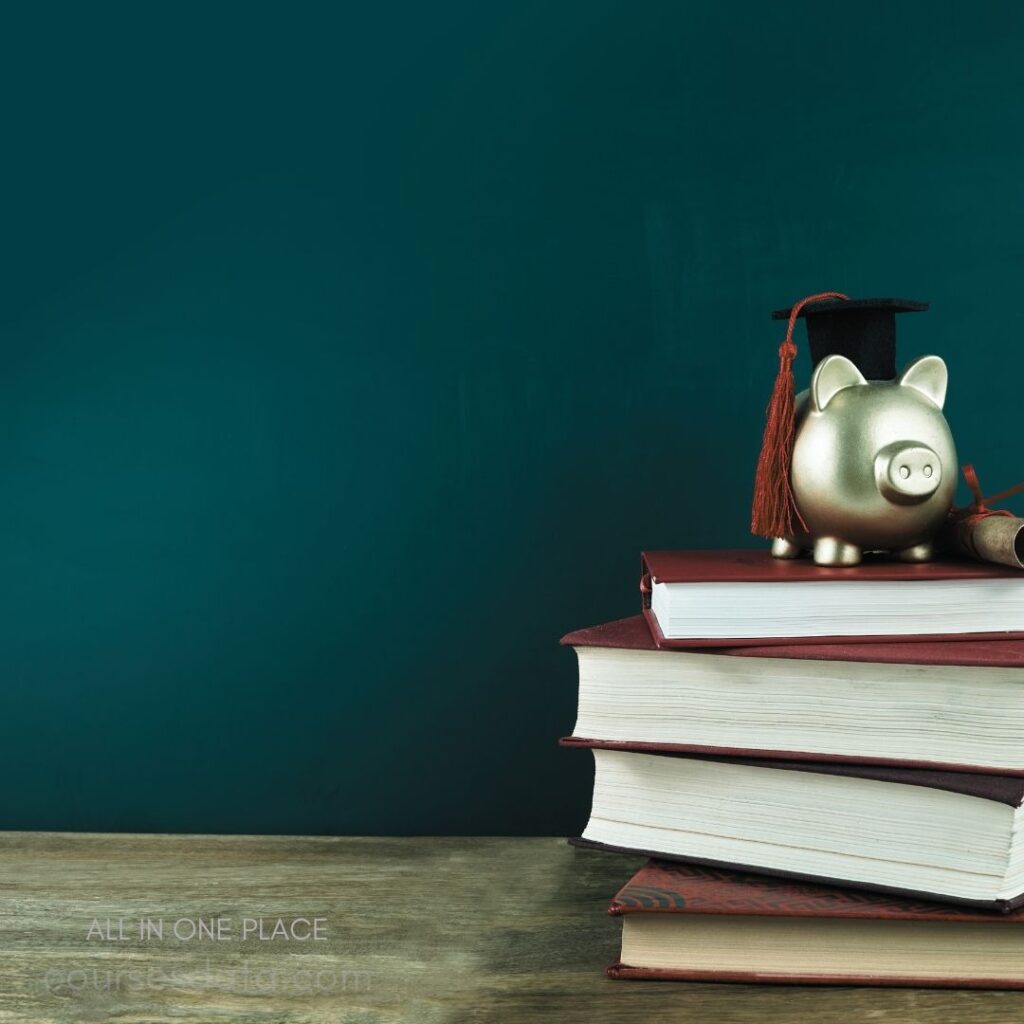 Gold piggy bank with cap. Stack of red books. Teal background, wooden surface. Education and savings theme.