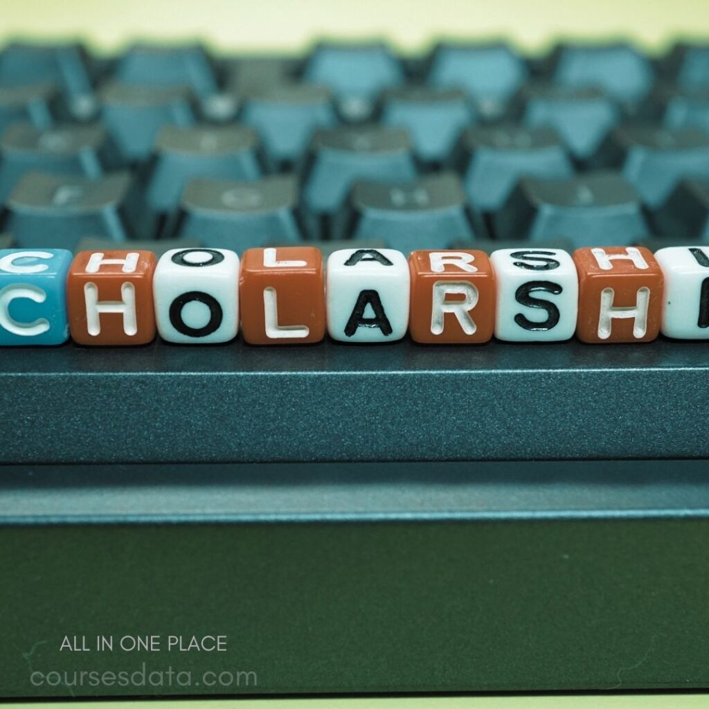 Colorful letter beads spelling "Scholarship" on keyboard.