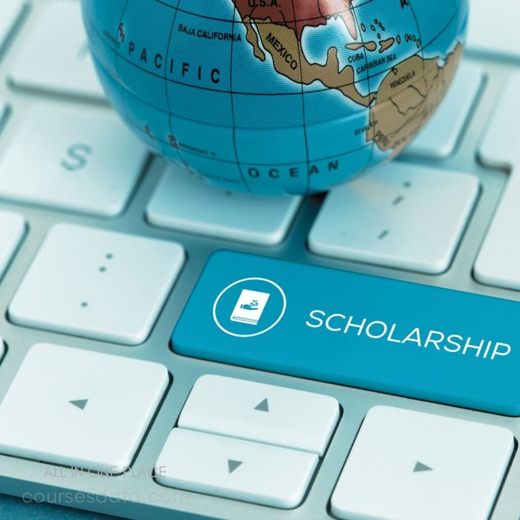 Globe on keyboard. Highlighted scholarship key. Close-up of keys. World map focus. Education theme imagery.