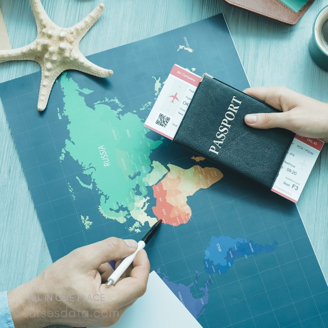 Map with Russia highlighted. Hands holding a black passport. Two flight tickets visible. Starfish on the table. Blue background and pen.