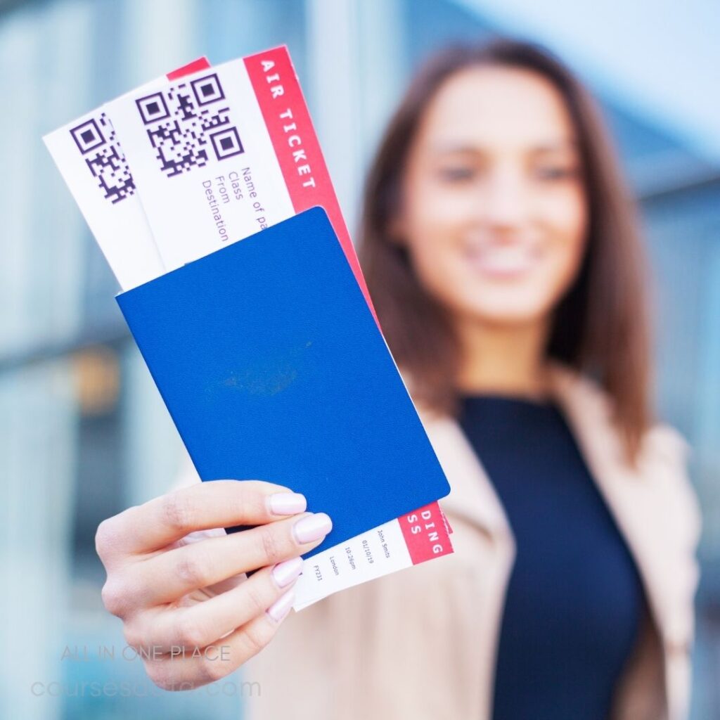 Air tickets and blue passport. Smiling woman holding tickets. Modern building in background. Bright daylight setting. Travel preparation moment.